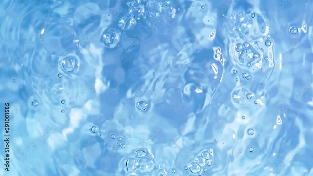 Top view slow motion of drop falling into the water surface and diverging circles on white background Top view slow motion of drop falling into the water surface and diverging circles on white background