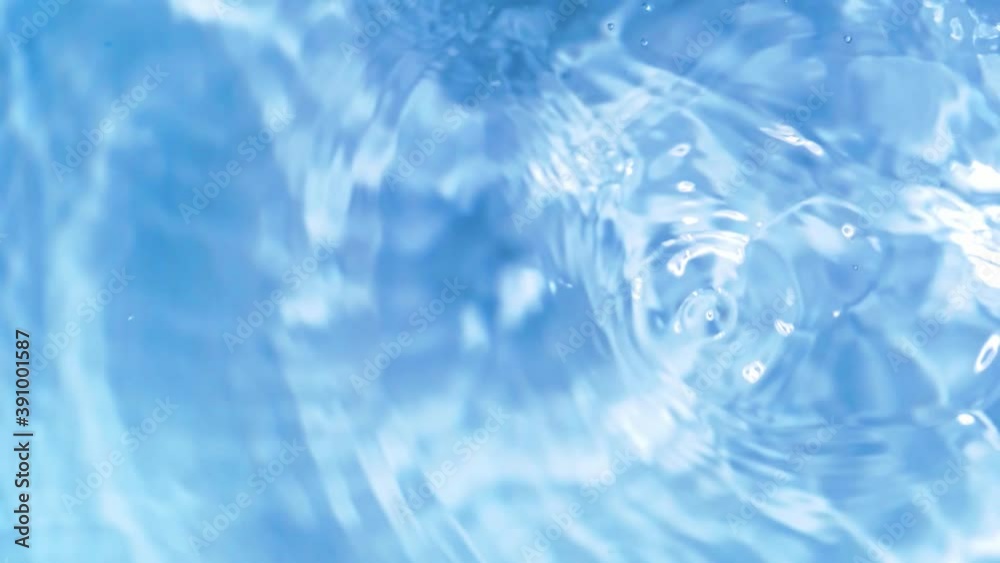 Top view slow motion of drop falling into the water surface and diverging circles on white background Top view slow motion of drop falling into the water surface and diverging circles on white background