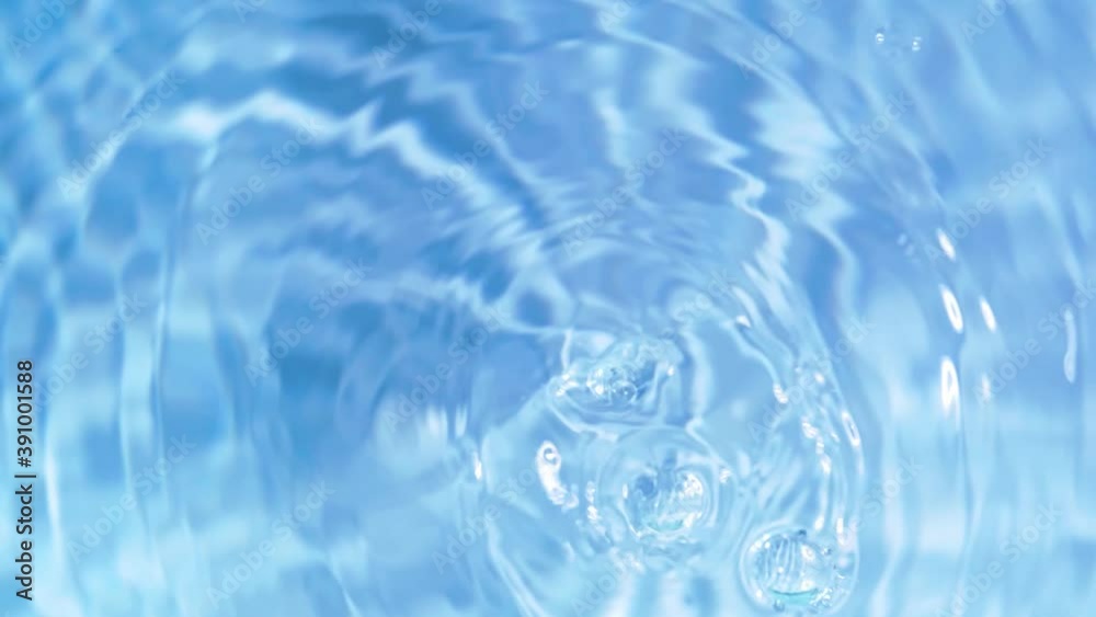 Top view slow motion of drop falling into the water surface and diverging circles on white background Top view slow motion of drop falling into the water surface and diverging circles on white background