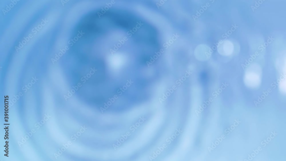Top view slow motion of drop falling into the water surface and diverging circles on white background