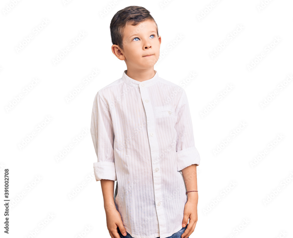 Cute blond kid wearing elegant shirt smiling looking to the side and staring away thinking. Cute blond kid wearing elegant shirt smiling looking to the side and staring away thinking.