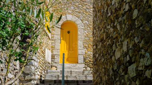 medieval street with yellow shutters and door at Montpezat 