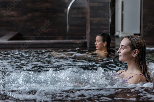 Tranquil woman in bubbling tub in spa resort