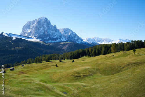 Beautiful langkofel mountain in the dolomites seen from the seceda alm with the first snow white and blue sky