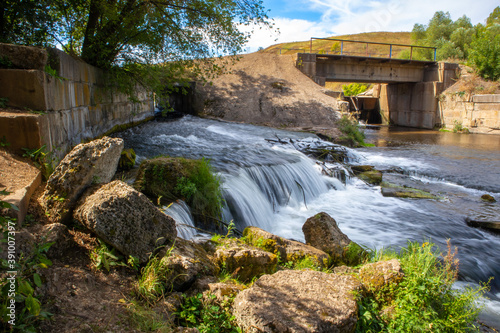 A flow of water and the dam on the river Vorgol. A place near the city of Yelets, Lipetsk region, Russia