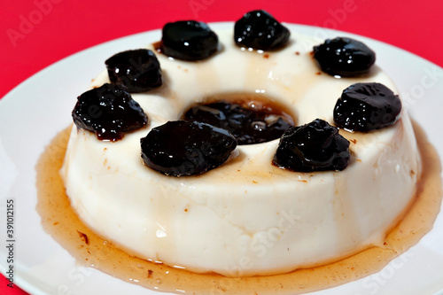 Photography Delicious traditional Brazilian dessert known as Manjar de Coco Branco with plum sauce