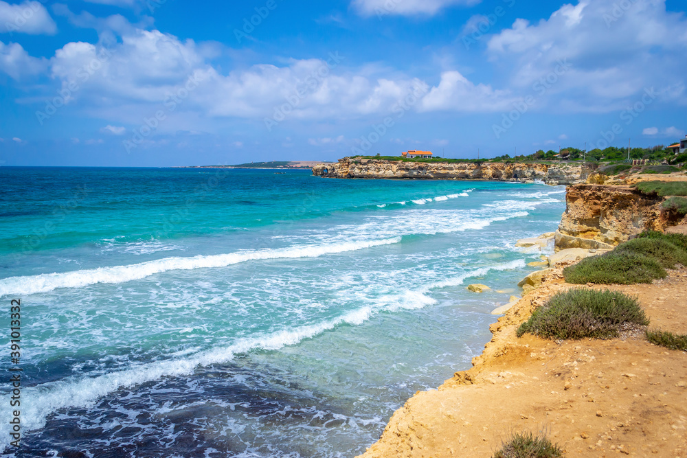 Cloudy sky over S'aena scoada beach in Sardinia