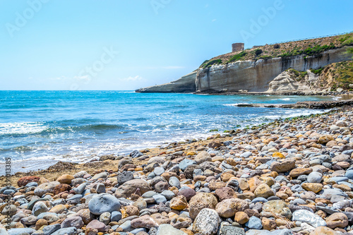 Fototapeta Rocks and sand by the sea in Santa Caterina di Pittinuri beach