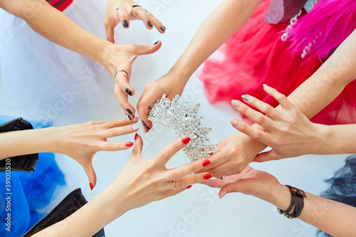 The girls ' hands reach for the crown. Who will be the Queen, the boss or the first beauty. The concept of competition and competition.