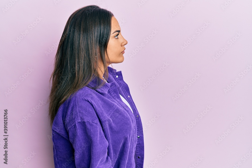 Young brunette woman wearing casual clothes looking to side, relax profile pose with natural face and confident smile. Young brunette woman wearing casual clothes looking to side, relax profile pose with natural face and confident smile.