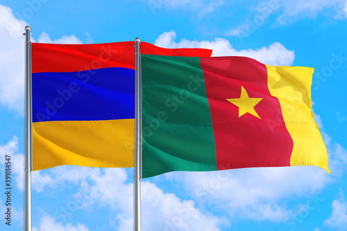 Cameroon and Armenia national flag waving in the windy deep blue sky. Diplomacy and international relations concept.