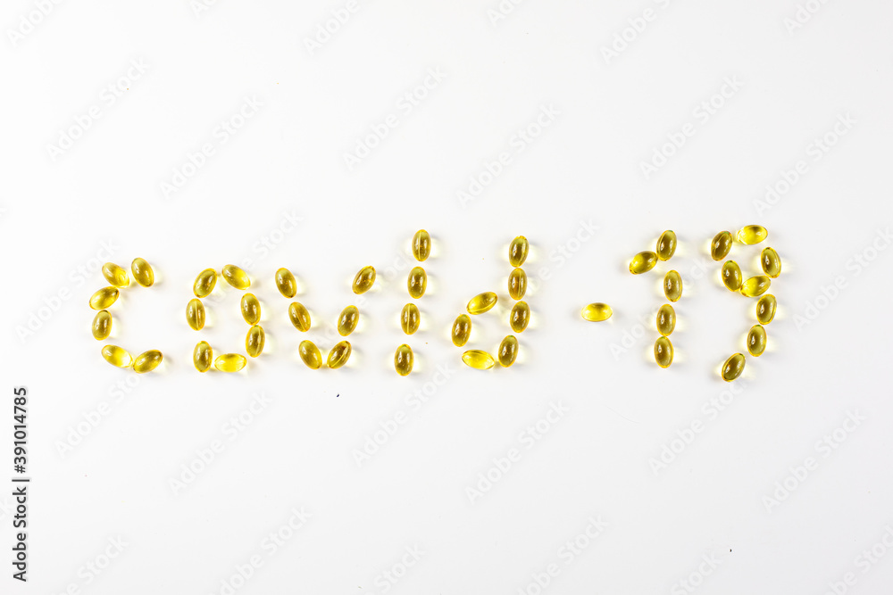 covid -19 laid out in the form of capsules with vitamin D  on a white background