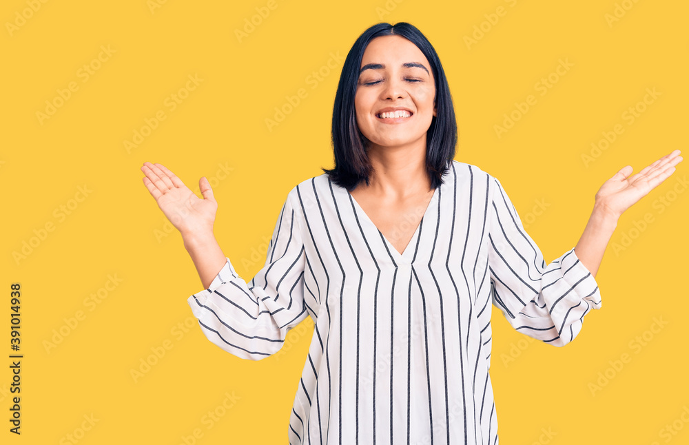 Young beautiful latin woman wearing casual clothes celebrating mad and crazy for success with arms raised and closed eyes screaming excited. winner concept Young beautiful latin woman wearing casual clothes celebrating mad and crazy for success with arms raised and closed eyes screaming excited. winner concept