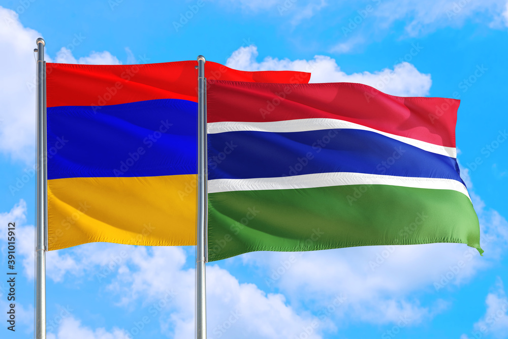 Gambia and Armenia national flag waving in the windy deep blue sky. Diplomacy and international relations concept. Gambia and Armenia national flag waving in the windy deep blue sky. Diplomacy and international relations concept.
