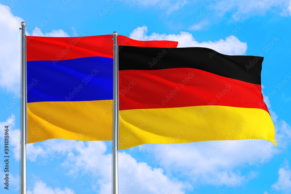 Germany and Armenia national flag waving in the windy deep blue sky. Diplomacy and international relations concept. Germany and Armenia national flag waving in the windy deep blue sky. Diplomacy and international relations concept.