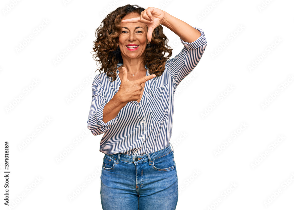 Middle age hispanic woman wearing casual clothes smiling making frame with hands and fingers with happy face. creativity and photography concept. Middle age hispanic woman wearing casual clothes smiling making frame with hands and fingers with happy face. creativity and photography concept.