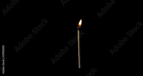 Full body shot of Match burning and combusting on black background. The match lights up, burns, and goes out. Burning matchstick lights and then blown out.