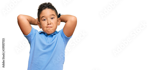 Little boy hispanic kid wearing casual clothes doing bunny ears gesture with hands palms looking cynical and skeptical. easter rabbit concept. photo