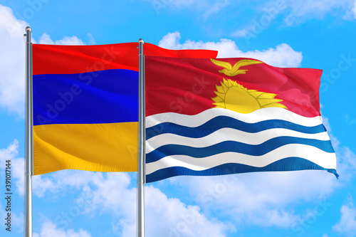 Kiribati and Armenia national flag waving in the windy deep blue sky. Diplomacy and international relations concept.