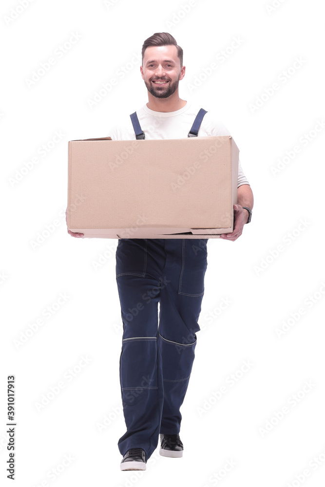 in full growth. smiling man carries a large cardboard box in full growth. smiling man carries a large cardboard box
