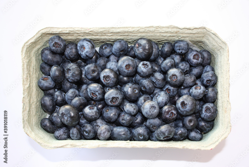 Sweet blueberry in packing containers, cardboard boxes with berries. Blue fruit in package, closeup. Healthy, delicious dessert in packaging. Sweet blueberry in packing containers, cardboard boxes with berries. Blue fruit in package, closeup. Healthy, delicious dessert in packaging.