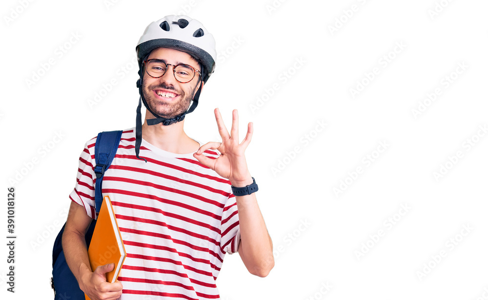 Young hispanic man wearing student backpack and bike helmet holding binder doing ok sign with fingers, smiling friendly gesturing excellent symbol Young hispanic man wearing student backpack and bike helmet holding binder doing ok sign with fingers, smiling friendly gesturing excellent symbol