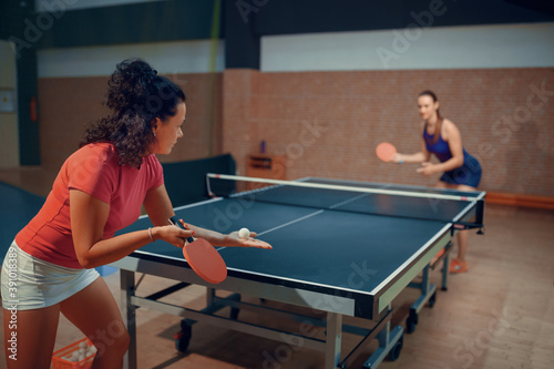 Women play ping pong match, table tennis