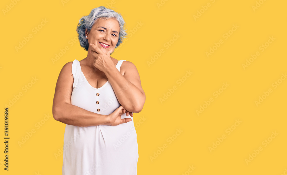 Senior woman with gray hair wearing casual clothes looking confident at the camera smiling with crossed arms and hand raised on chin. thinking positive. Senior woman with gray hair wearing casual clothes looking confident at the camera smiling with crossed arms and hand raised on chin. thinking positive.