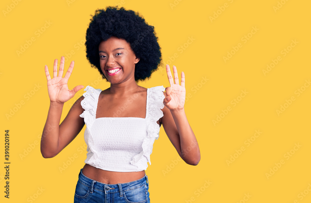 Young african american woman wearing casual clothes showing and pointing up with fingers number eight while smiling confident and happy. Young african american woman wearing casual clothes showing and pointing up with fingers number eight while smiling confident and happy.