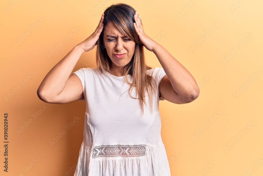 Young beautiful woman wearing casual t shirt with hand on head, headache because stress. suffering migraine.