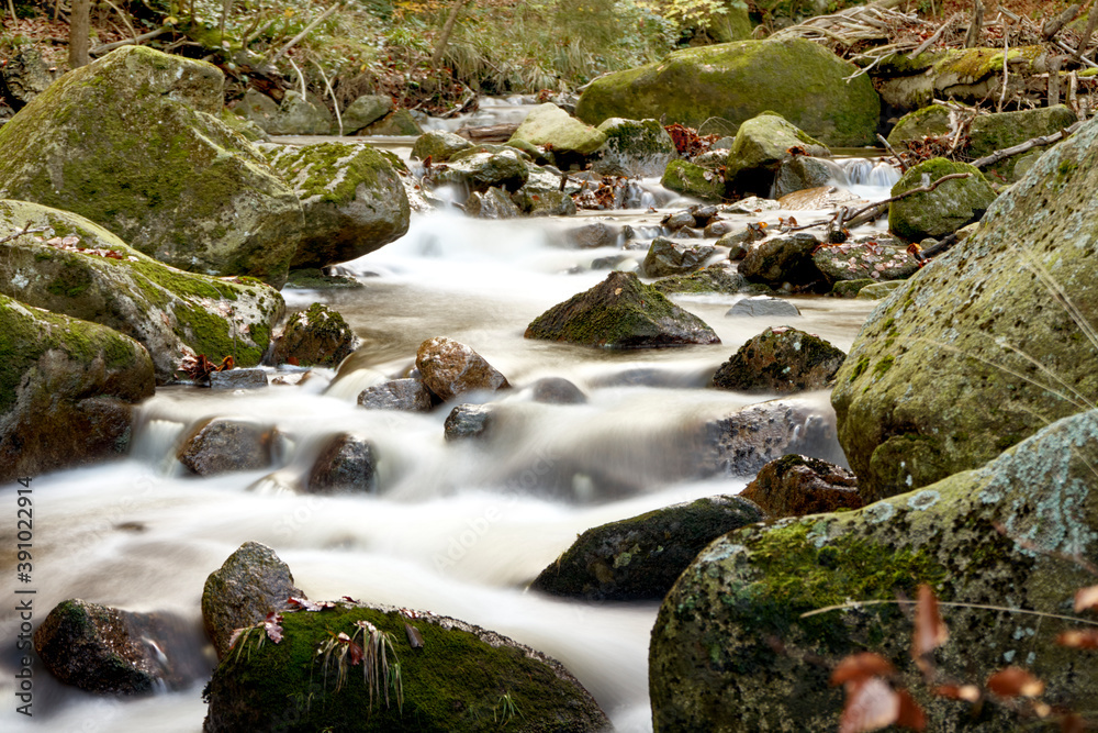 stream with stones in the mountains, white foaming gout alienated by long-term exposure stream with stones in the mountains, white foaming gout alienated by long-term exposure