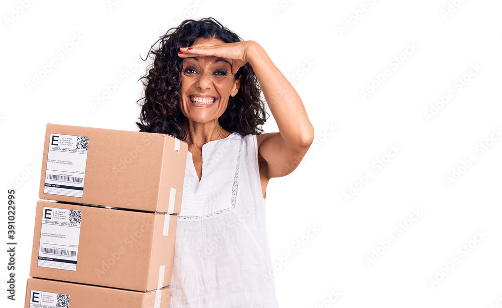Middle age beautiful woman holding delivery package stressed and frustrated with hand on head, surprised and angry face Middle age beautiful woman holding delivery package stressed and frustrated with hand on head, surprised and angry face