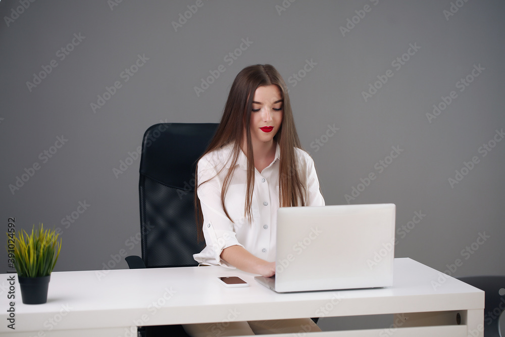 young female student sitting in the office solving problems young female student sitting in the office solving problems
