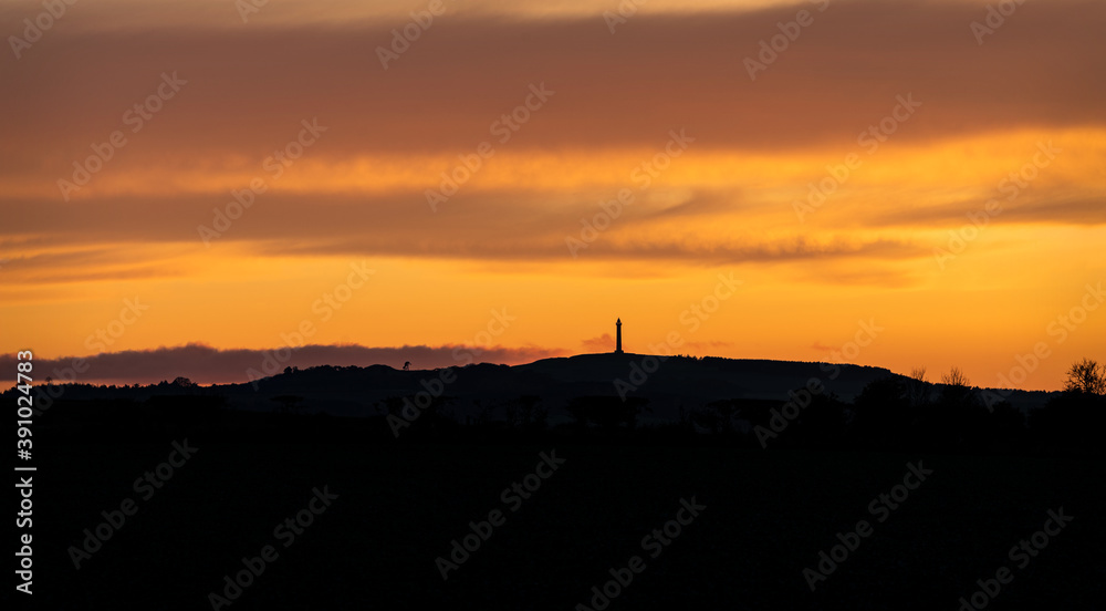 Scottish Borders  at sunset with the Waterloo Monument in silhouette, Scottish Borders, UK