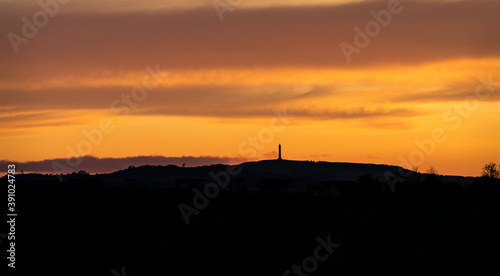 Scottish Borders at sunset with the Waterloo Monument in silhouette, Scottish Borders, UK