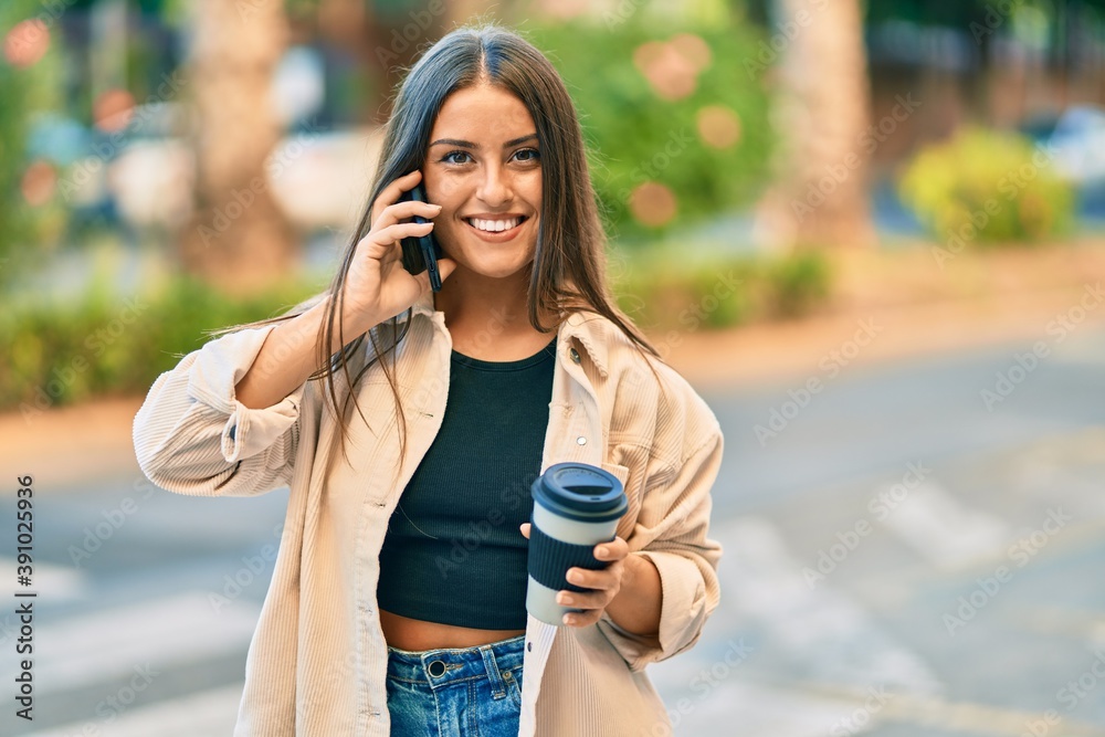 Young hispanic girl smiling happy talking on the smartphone and drinking take away coffee at the park. Young hispanic girl smiling happy talking on the smartphone and drinking take away coffee at the park.