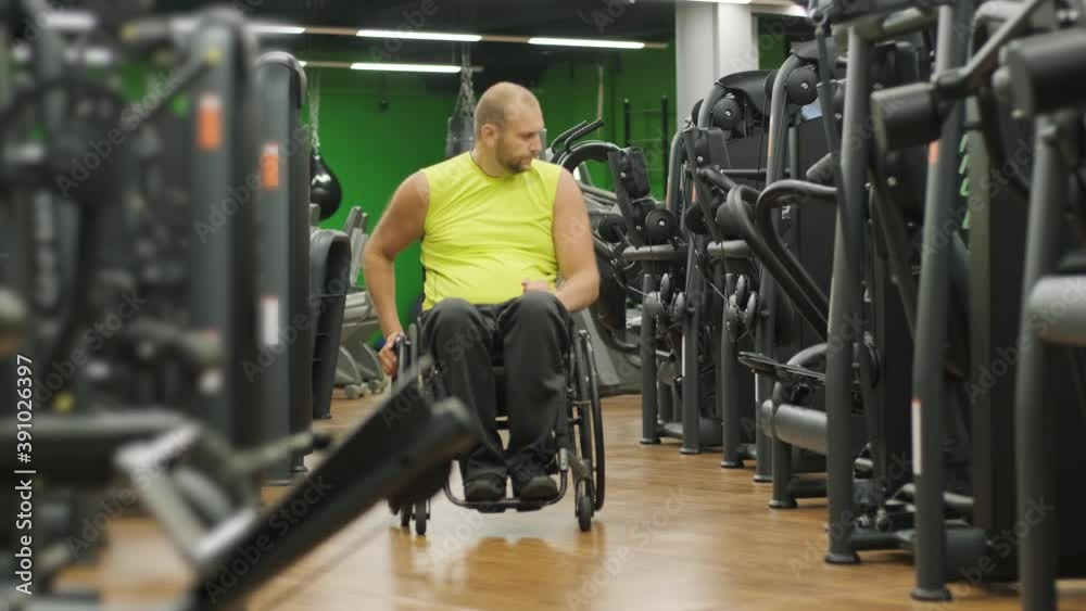 Disabled man training in the gym of rehabilitation center Disabled man training in the gym of rehabilitation center