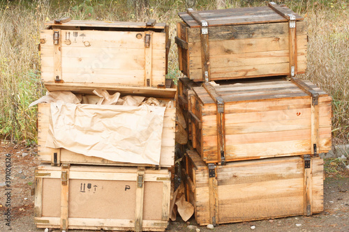 A pile of an old russian USSR army wooden weapon boxes for machine guns in the forest also good for illegal arms trade concept
