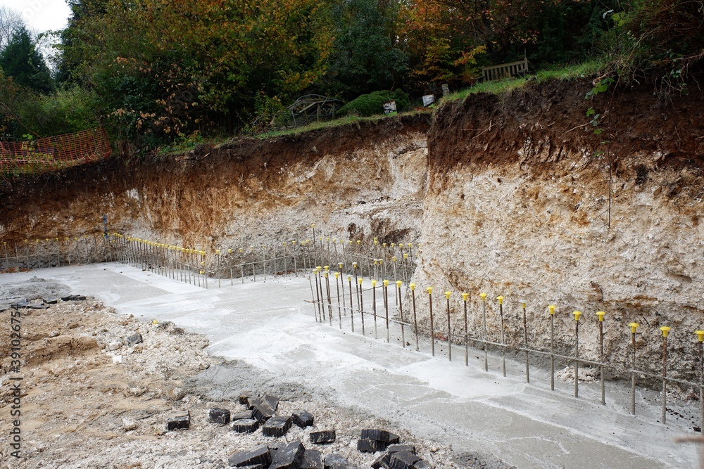 Concrete retaining wall footing reinforced with steel rebar Stock Photo