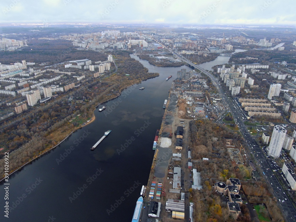 Fototapeta premium Aerial view panoramic cityscape with great height. River in a big city from a drone