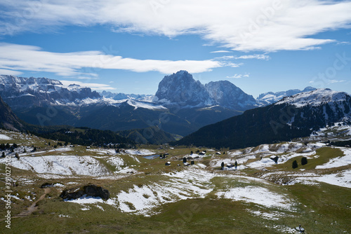 Beautiful langkofel mountain in the dolomites seen from the seceda alm with the first snow white and blue sky
