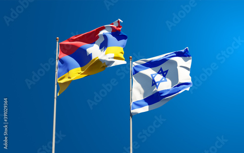Beautiful national state flags of Israel and Artsakh together at the sky background. 3D artwork concept.