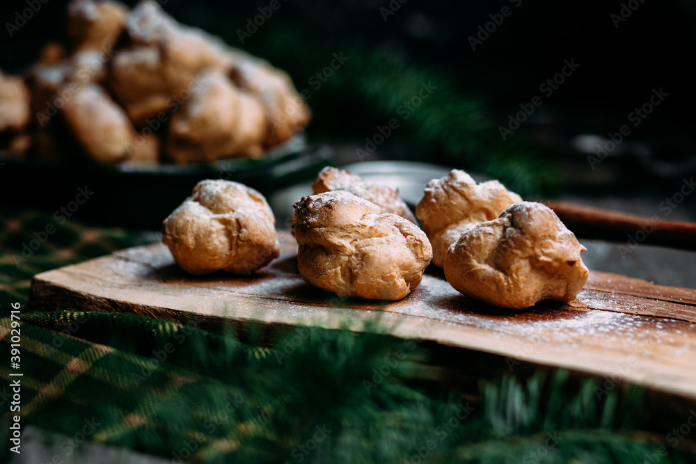 Profiteroles with custard on the table Profiteroles with custard on the table