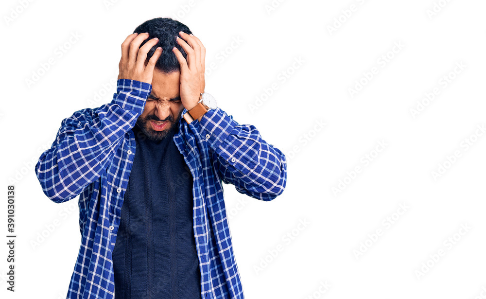 Young hispanic man wearing casual clothes suffering from headache desperate and stressed because pain and migraine. hands on head. Young hispanic man wearing casual clothes suffering from headache desperate and stressed because pain and migraine. hands on head.