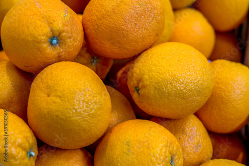 Lots of oranges on the supermarket counter. pattern of oranges. Citrus fruit.