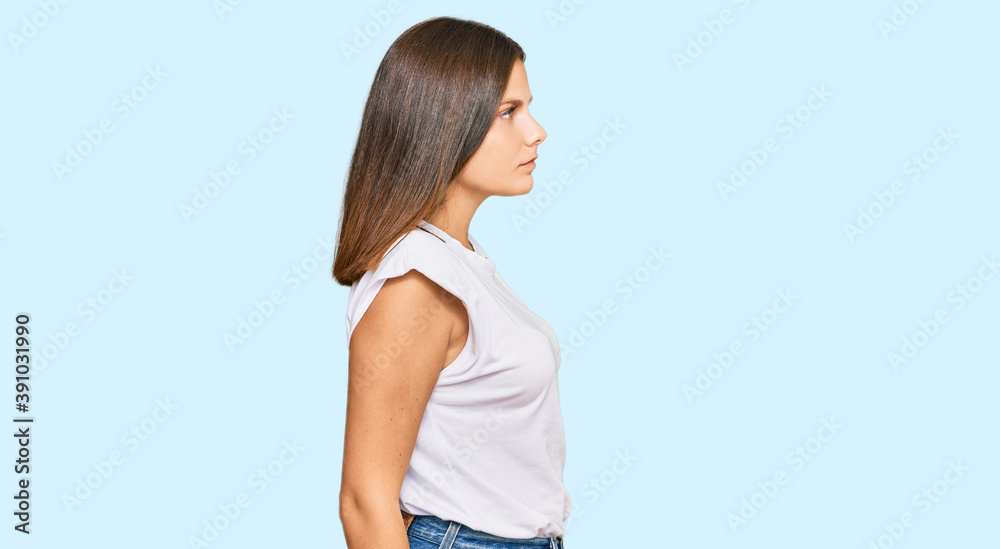 Young caucasian woman wearing casual white tshirt looking to side, relax profile pose with natural face with confident smile. Young caucasian woman wearing casual white tshirt looking to side, relax profile pose with natural face with confident smile.
