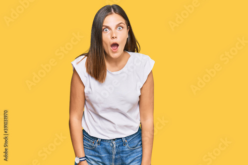 Young caucasian woman wearing casual white tshirt afraid and shocked with surprise expression, fear and excited face.