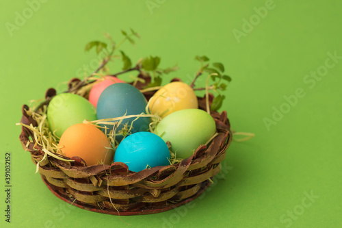 Easter basket with eggs decorated with a sprig with green young leaves