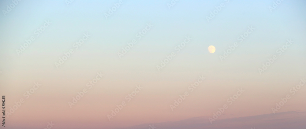 Moon and sunset in the sky