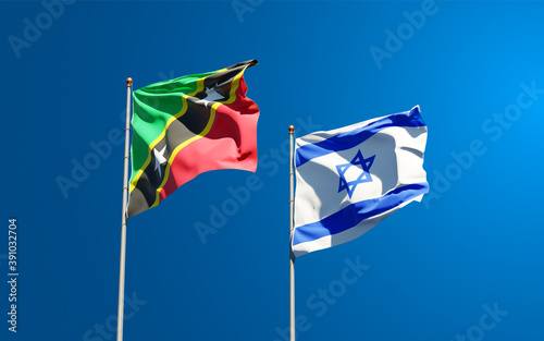 Beautiful national state flags of Saint Kitts and Nevis and Israel together at the sky background. 3D artwork concept.